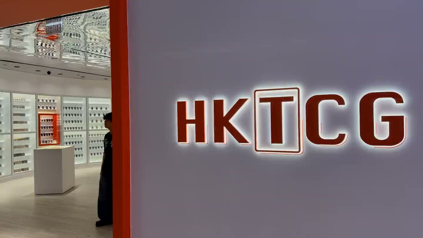 The HKTCG entrance reveals its illuminated card wall and logo.