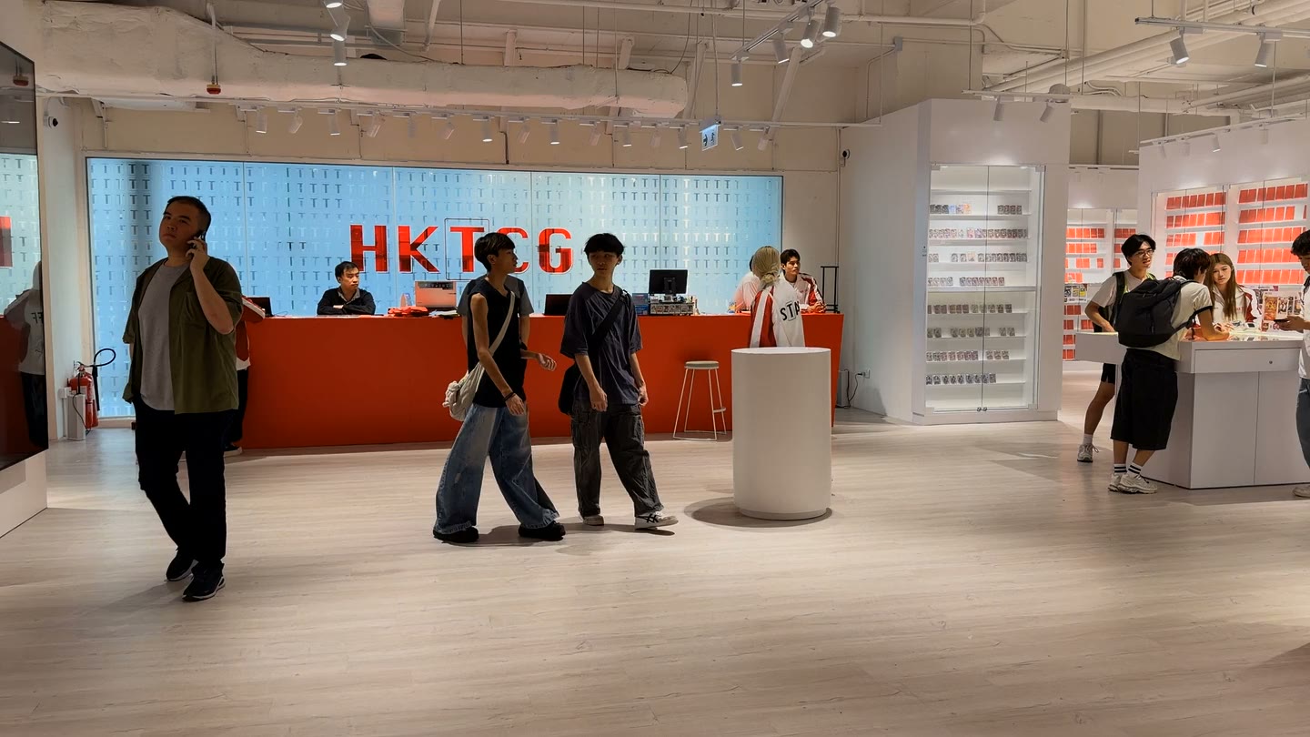 Visitors gather at the red HKTCG service counter.